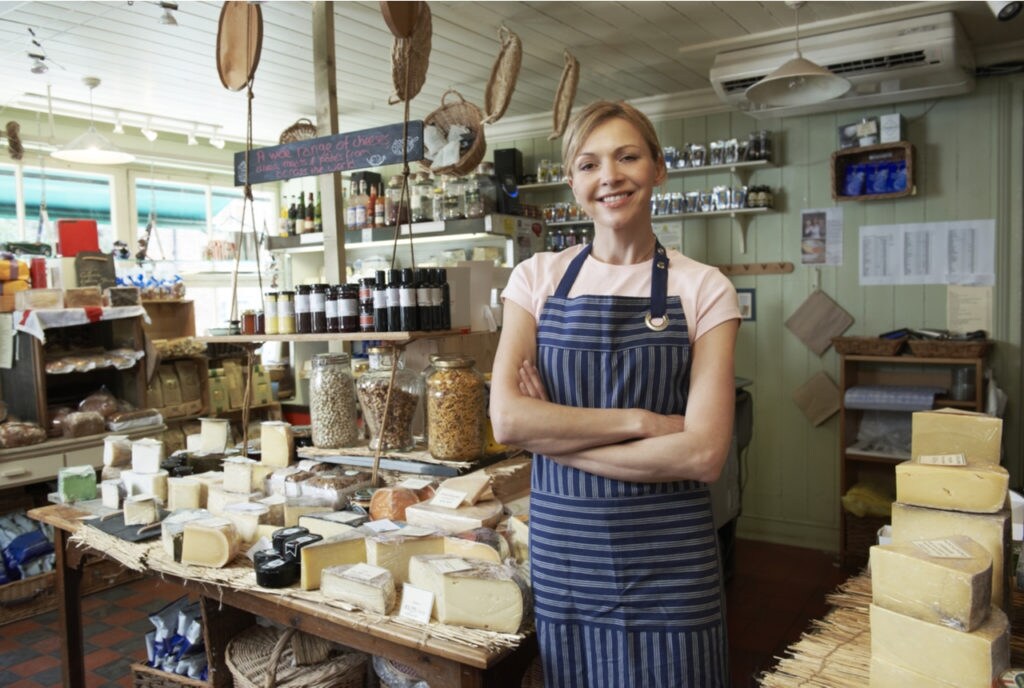 Woman smiling at camera inside bakery